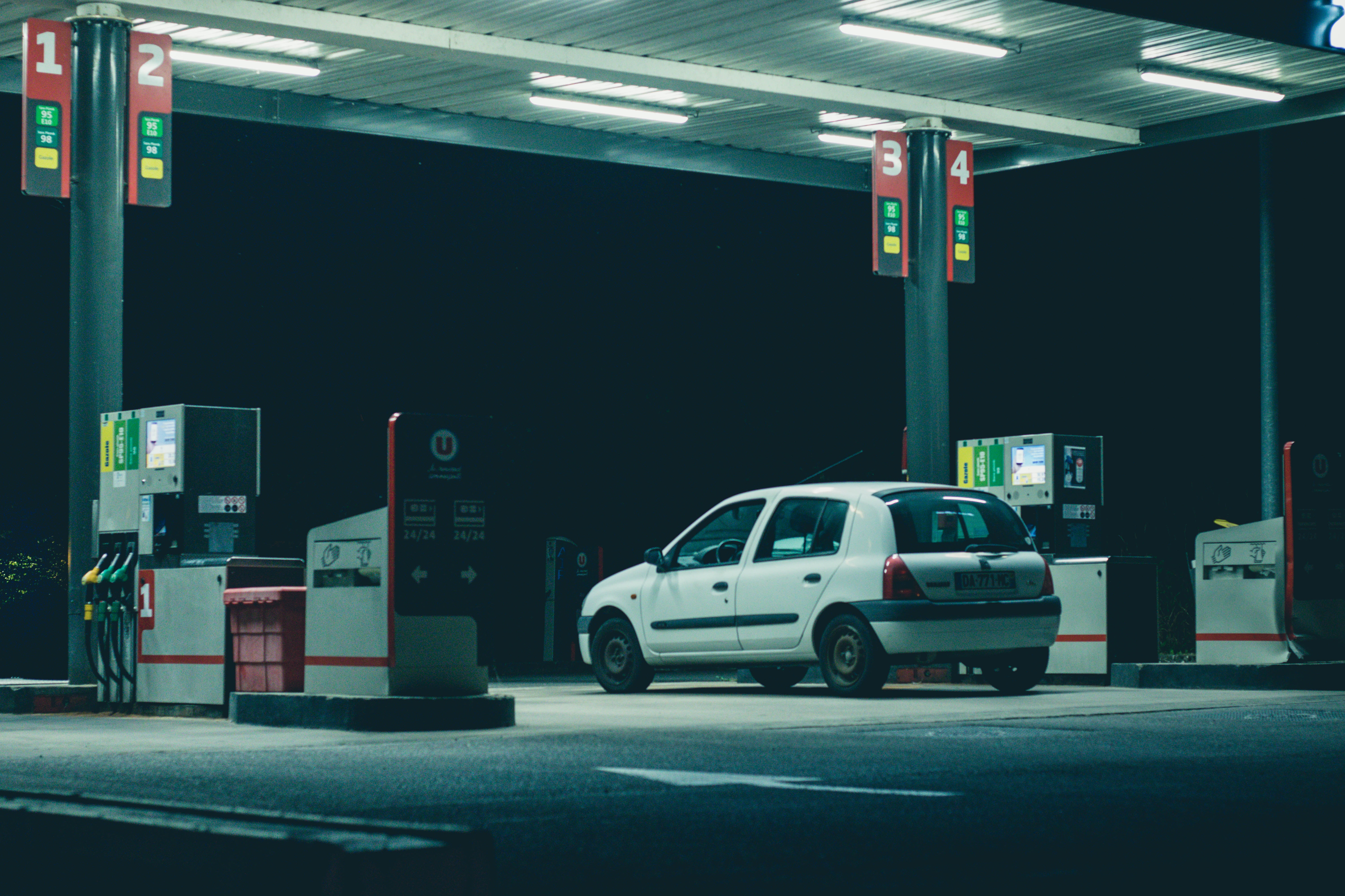 Oustide gas station at night. trick parked by one of the pumps